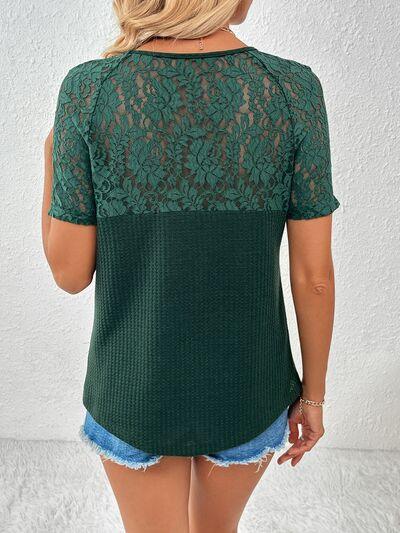 a woman wearing a green top with lace detailing