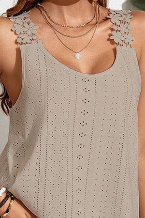 a woman wearing a tan tank top with cut outs