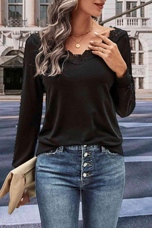 a woman wearing a black top and jeans