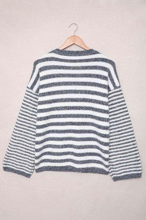 a striped sweater hanging on a hanger