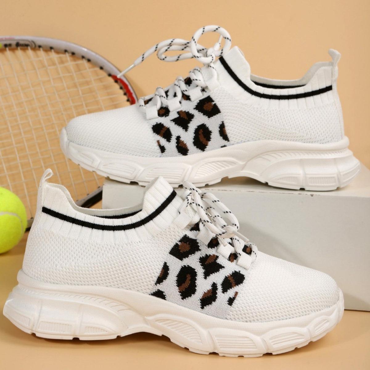 a tennis racket and a pair of shoes on a table
