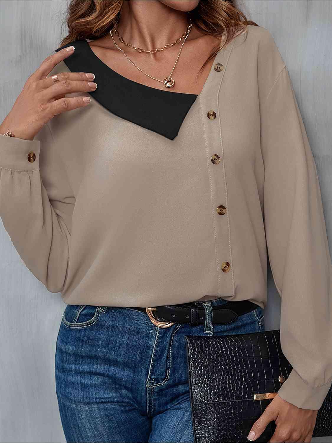 a woman wearing a tan blouse and jeans