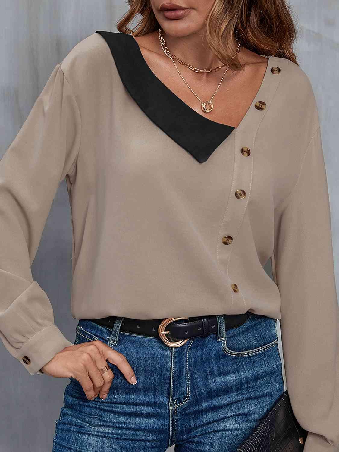 a woman wearing a tan blouse and jeans