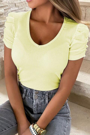 a woman wearing a yellow top and jeans