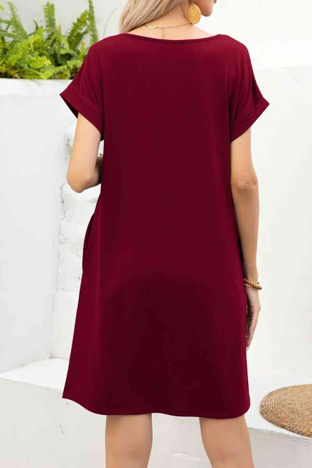 the back of a woman wearing a maroon shift dress