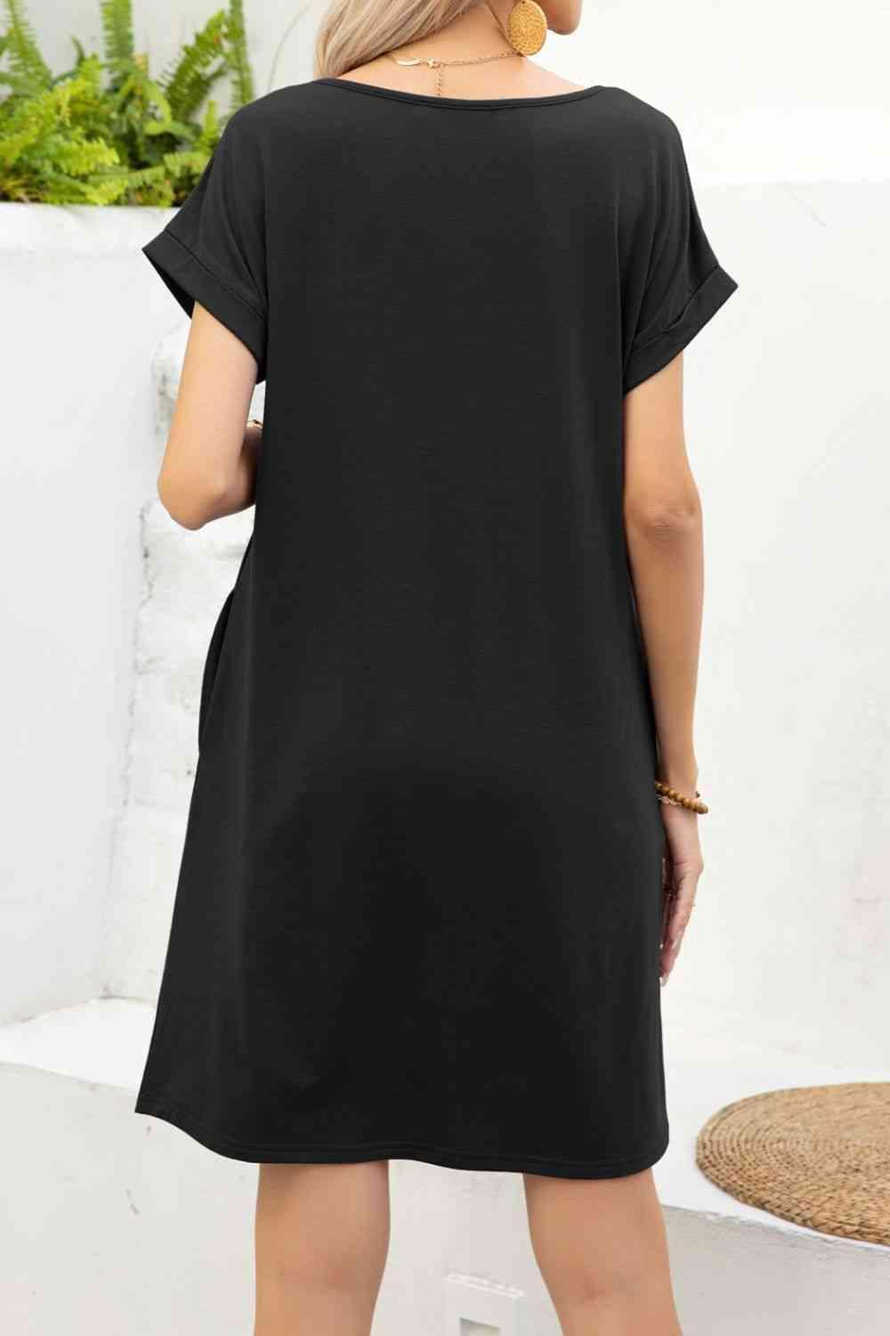 a woman wearing a black shift dress