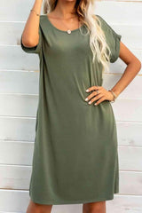 a woman in a green dress posing for a picture