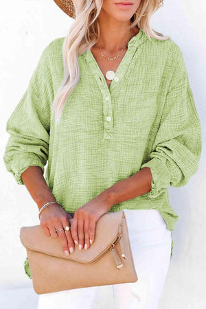 a woman wearing a straw hat and green shirt