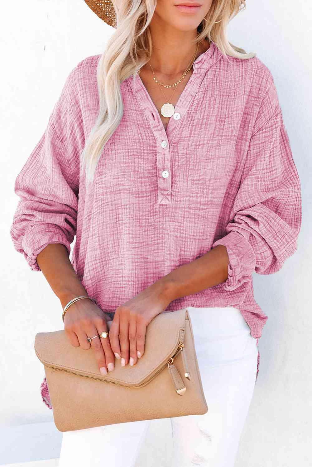 a woman wearing a straw hat and a pink shirt