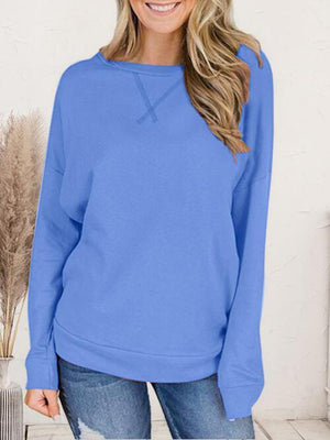 a woman wearing a blue sweater and jeans