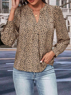 a woman wearing a leopard print shirt and jeans