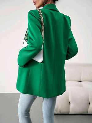 a woman wearing a green coat and jeans