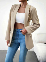 a woman in a crop top and jacket posing for a picture