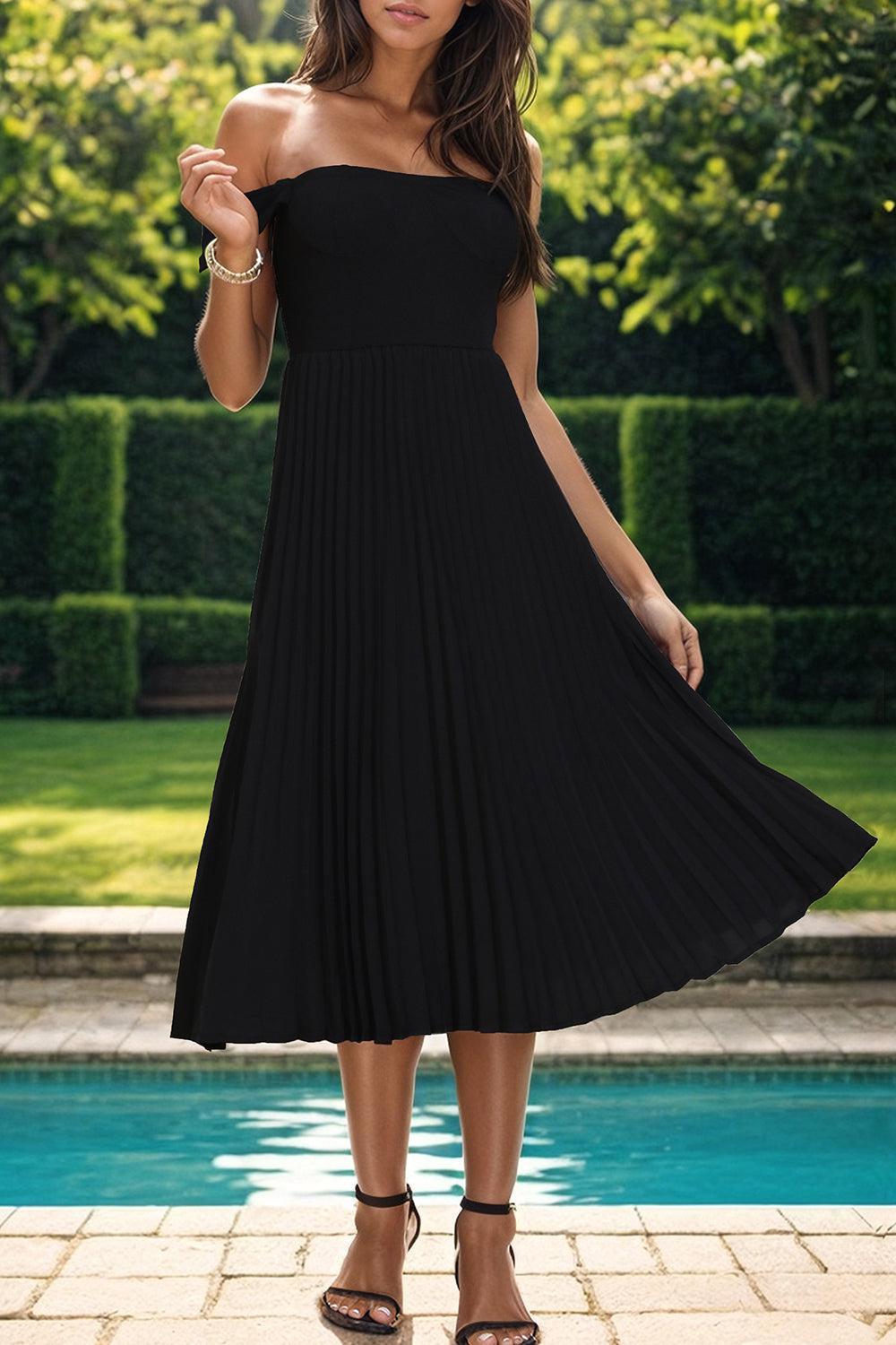 a woman in a black dress standing in front of a pool