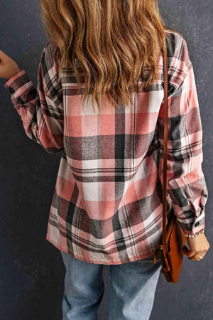 a woman wearing a plaid shirt and jeans