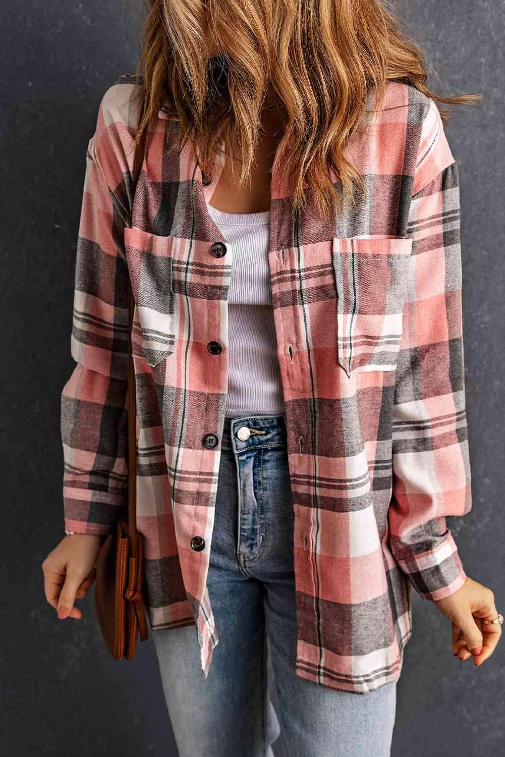 a woman wearing a plaid shirt and jeans