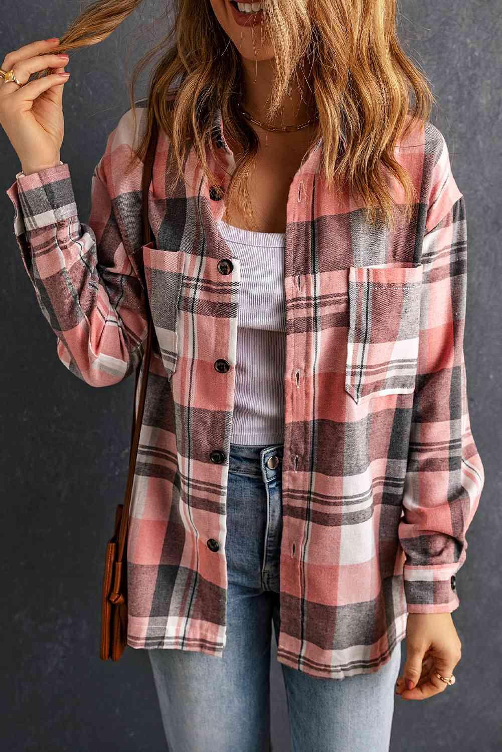a woman wearing a pink and black plaid shirt