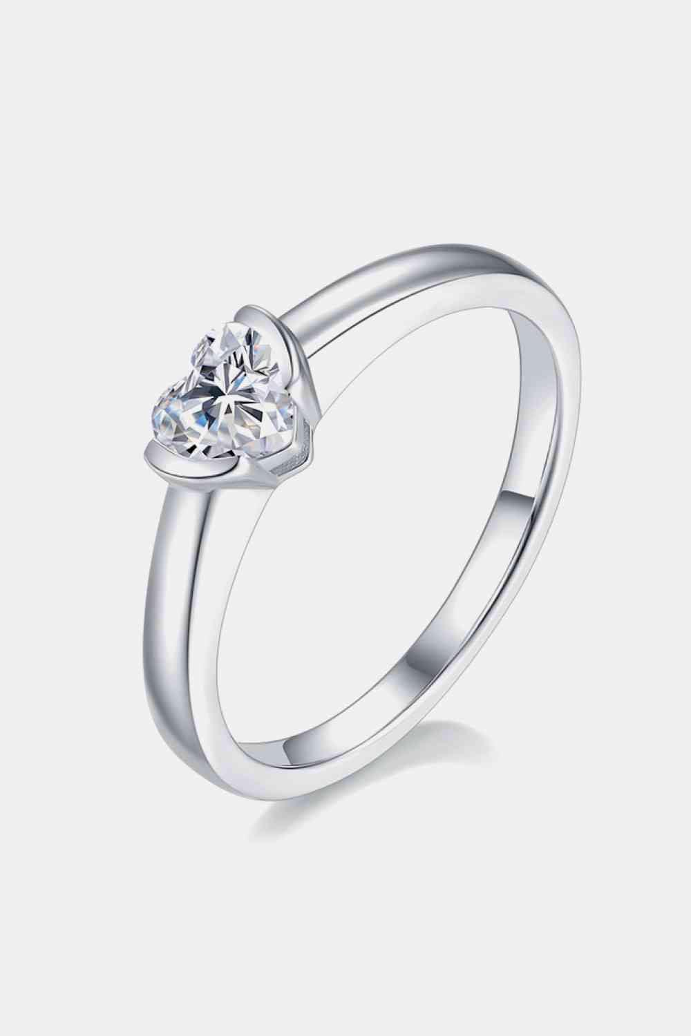 a white gold ring with a heart shaped diamond