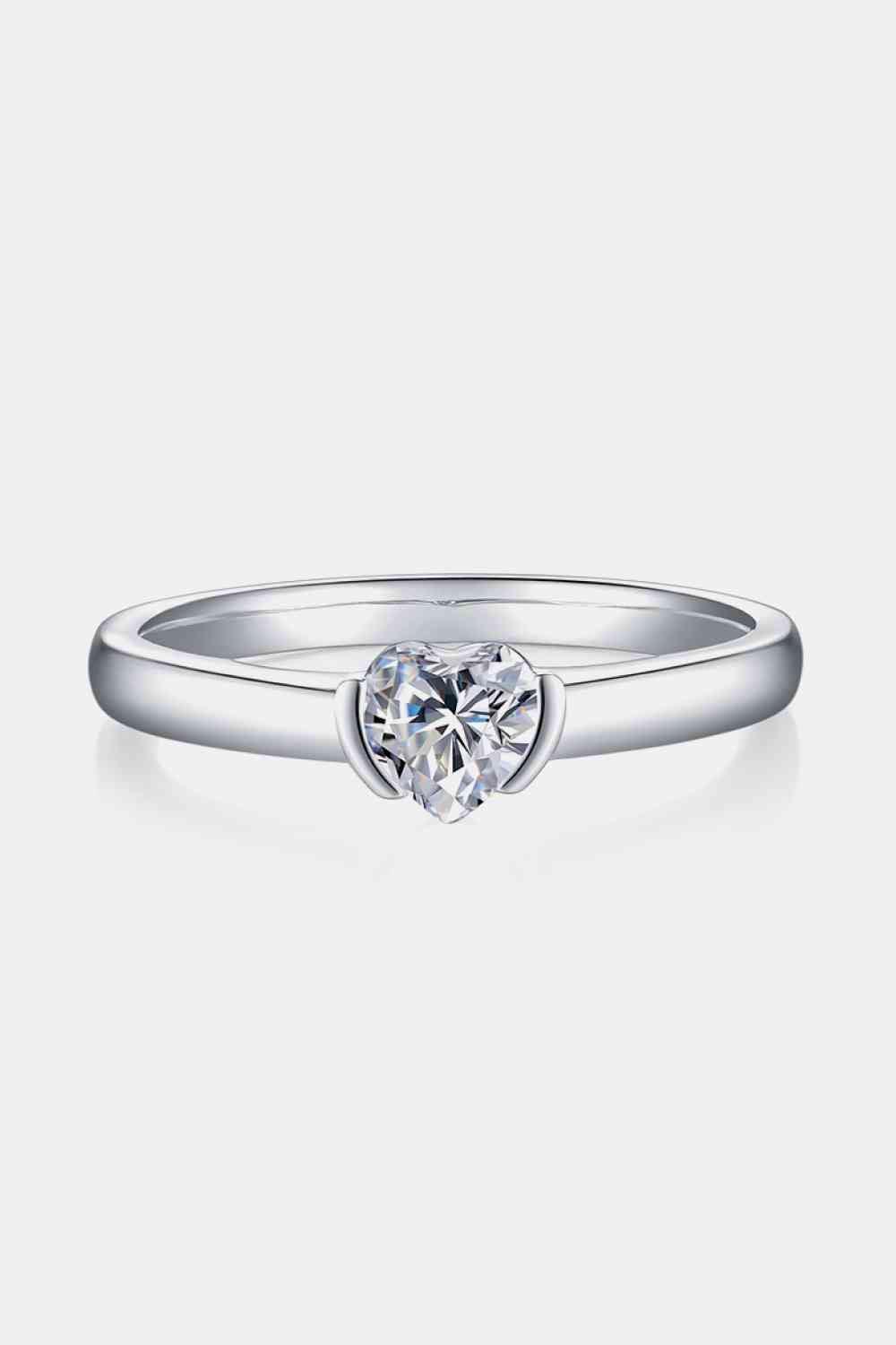 a white gold ring with a heart shaped diamond