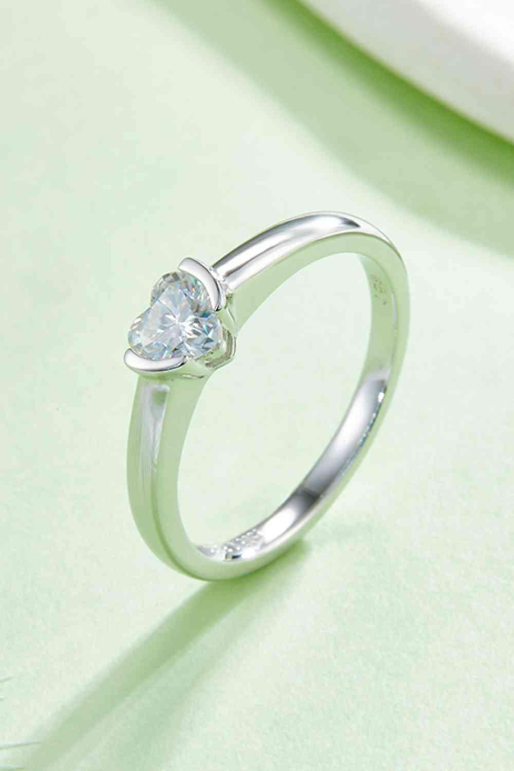 a white gold ring with a pear shaped diamond