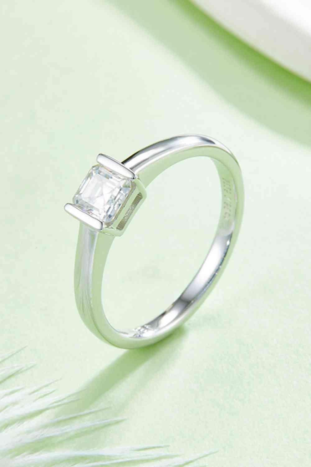 a white gold ring with a princess cut diamond