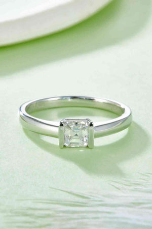 a white gold ring with a princess cut diamond