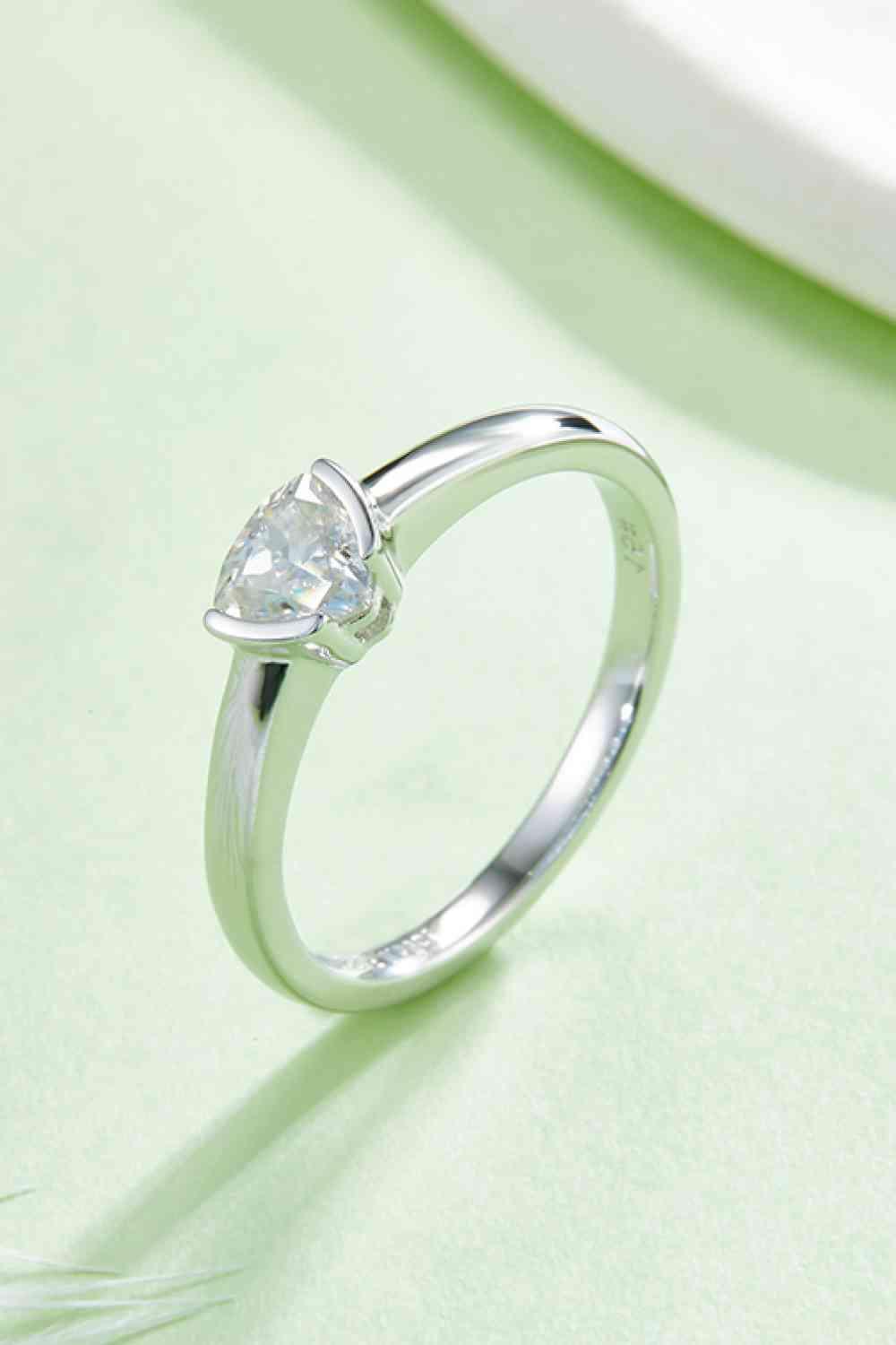 a white gold ring with a heart shaped diamond