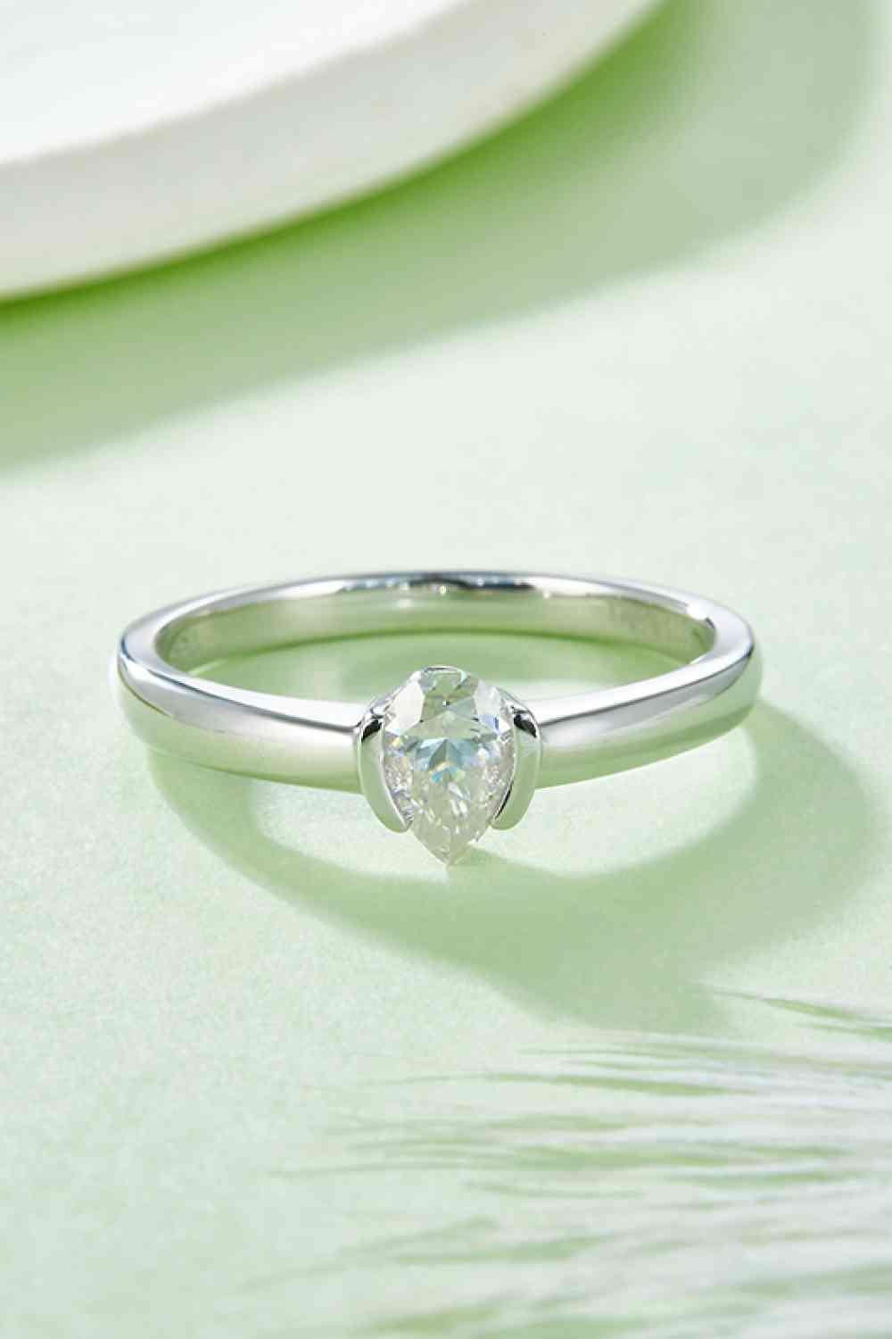 a close up of a diamond ring on a table