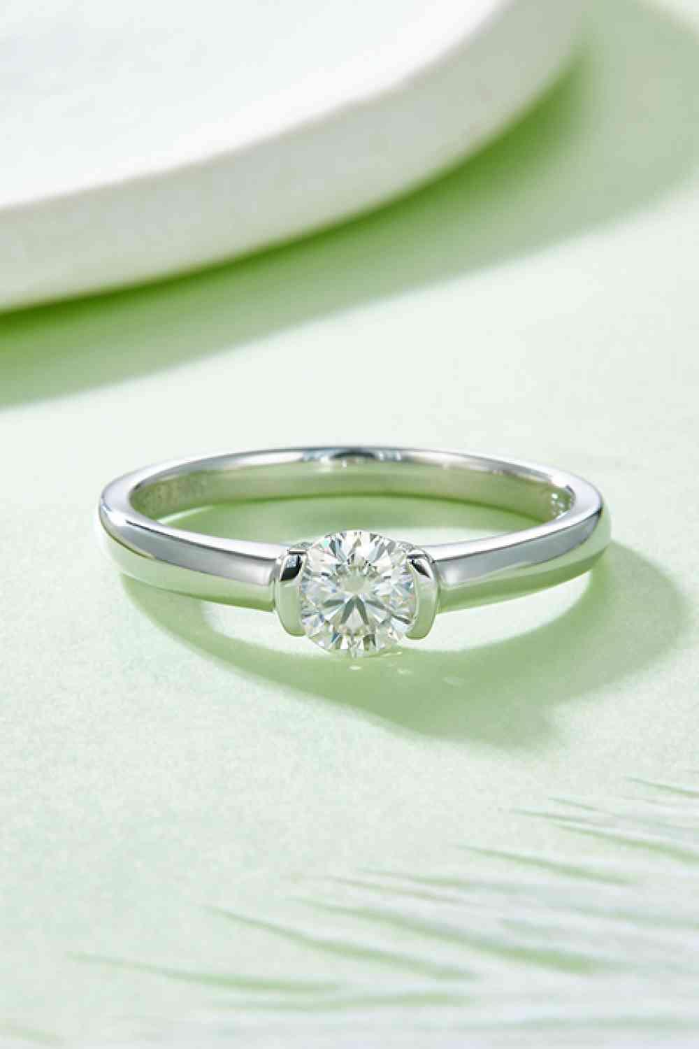 a close up of a diamond ring on a table