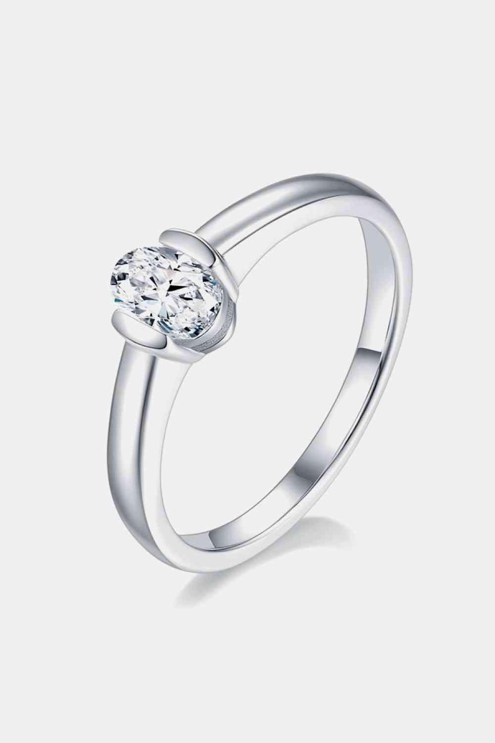 a white gold ring with a single diamond