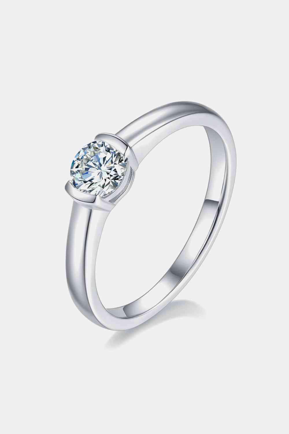 a white gold ring with a single diamond