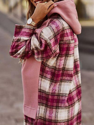 a woman in a pink and white checkered coat