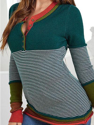 a woman wearing a green and red striped sweater
