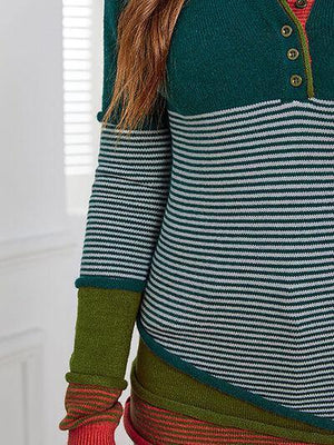 a woman wearing a green and red striped sweater