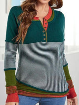 a woman wearing a green and red striped sweater