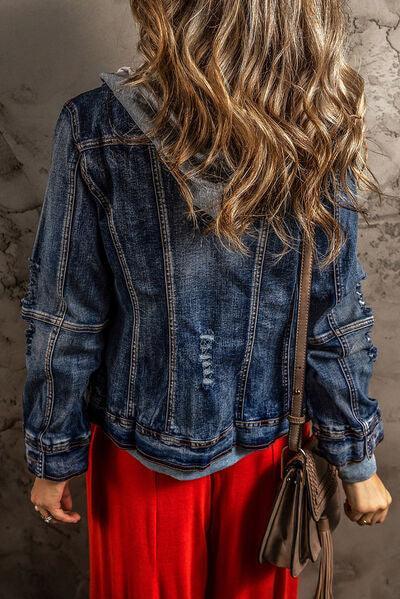 a woman wearing a jean jacket and red pants