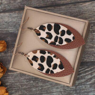 a pair of leopard print earrings in a box