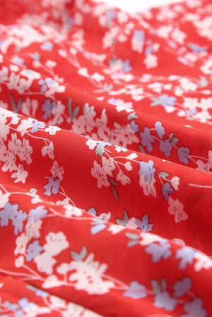 a close up of a red and white flowered fabric