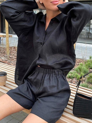 a woman sitting on top of a wooden bench