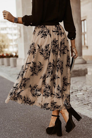 a woman walking down a street wearing a skirt