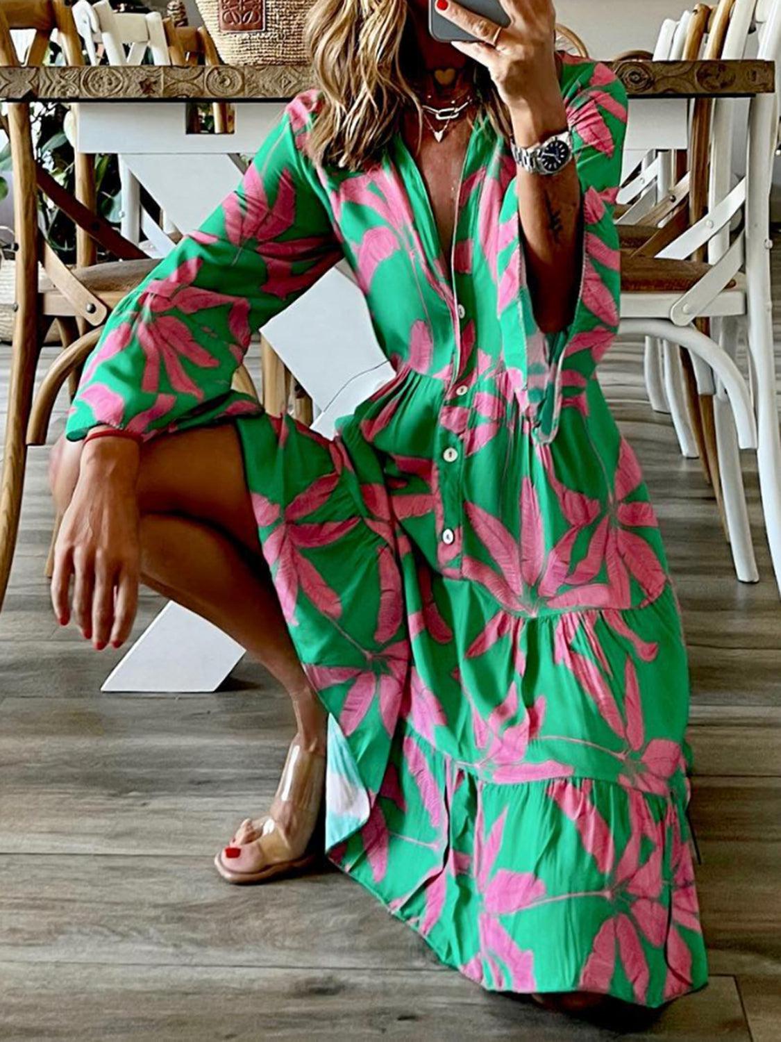 a woman sitting on the floor in a green and pink dress