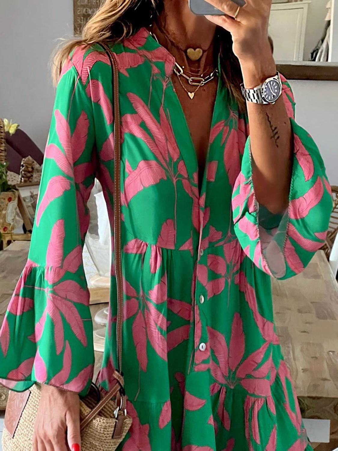 a woman taking a selfie while wearing a green and pink dress