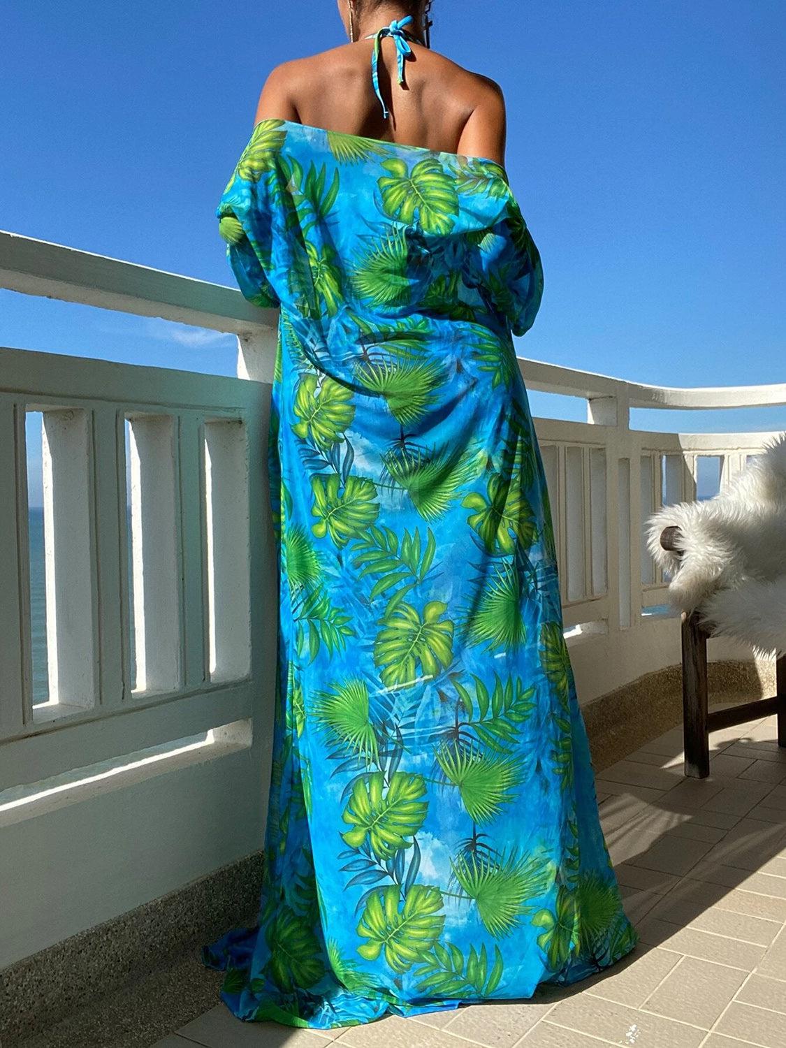 a woman in a blue dress standing on a balcony