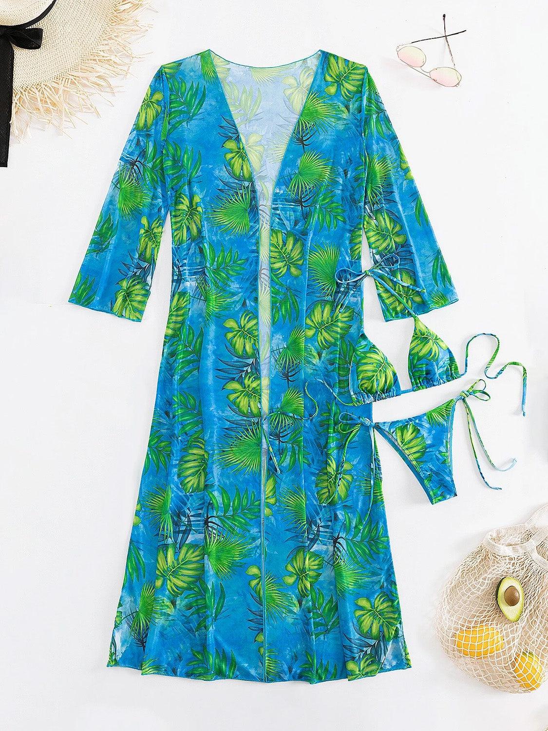 a women's blue and green dress next to a straw hat