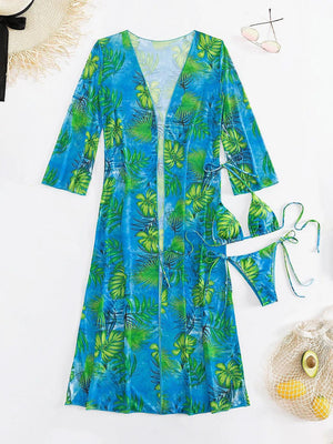 a women's blue and green dress next to a straw hat