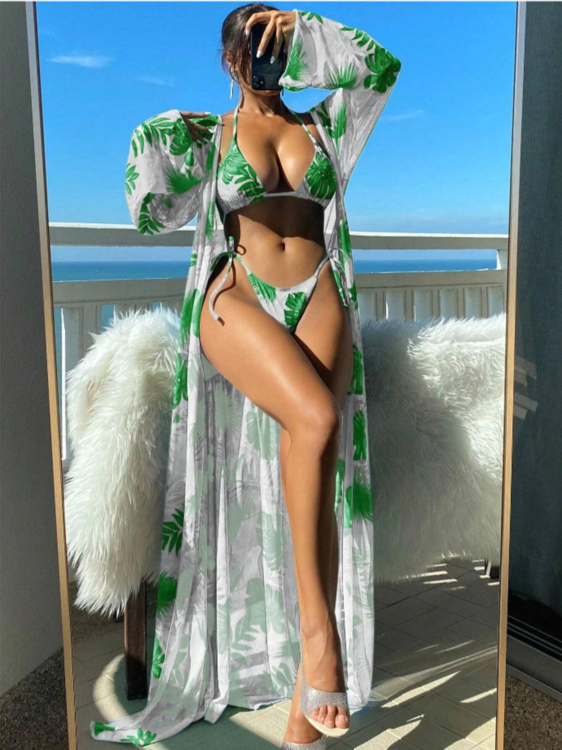 a woman in a green and white bikini is posing in front of a mirror