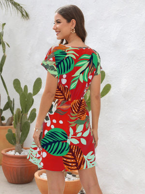 a woman standing in front of a potted plant