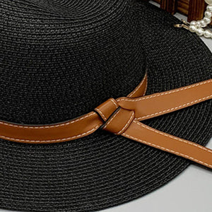 a black hat with a brown ribbon around it