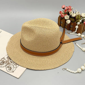 a hat, pearls and a necklace on a table