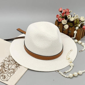 a white hat with a brown belt and pearls